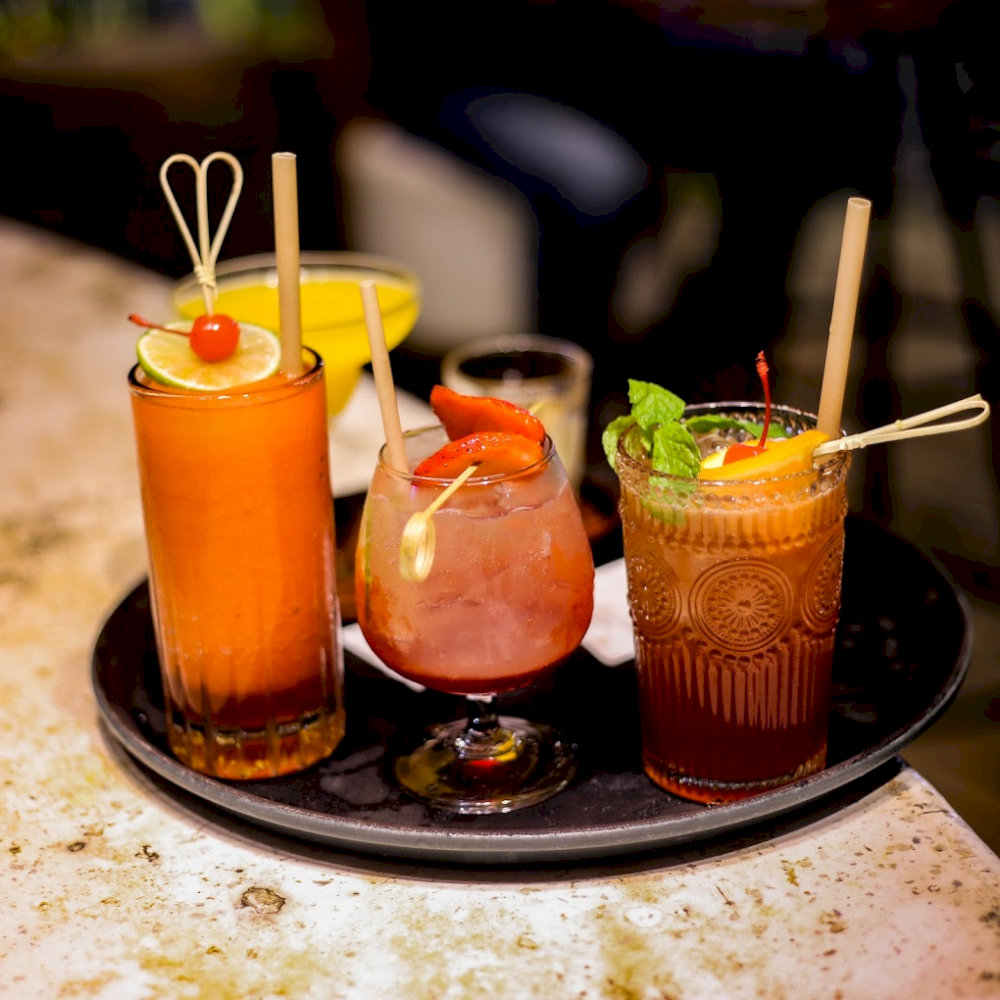 Cocktails made with fresh fruits and local ingredients offer a refreshing burst of flavor, perfect for relaxing by the beach 